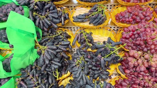 Assorted Fresh Grape Varieties on Supermarket Shelf &ndash; Green, Red and Black Seedless and Seeded Grapes in Different Sizes and Colors