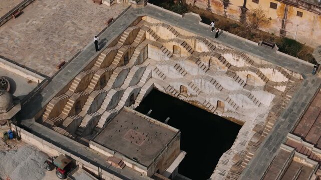 Aerial view of panna meena ka kund stepwell in jaipur with tourists exploring the ancient architecture