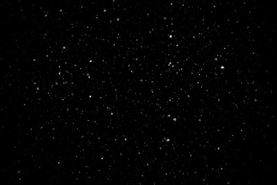 Sparse fine snow dust and tiny snowflakes isolated on black background overlay