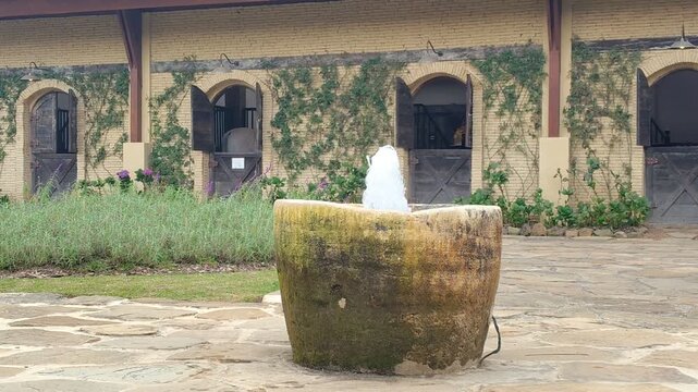 Vintage Stone Fountain In Rustic Horse Stable