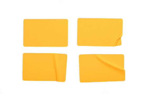 Set of four yellow paper sticker isolated on a white background. Realistic paper texture featuring creases, folds, and curled corners.