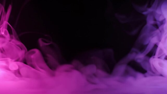 Pink and blue smoke swirling against a black background in a horizontal panoramic composition