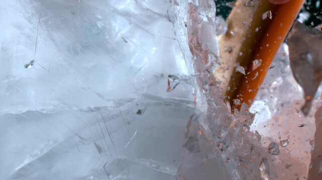 Macro close-up of an ice pick striking and cracking solid ice, revealing intricate fractures and crystal fragments with a powerful, tactile and cinematic frozen texture.