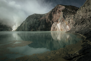 Dramatic Landscape of Kawah Ijen Crater Lake with Volcanic Steam and Acidic Turquoise Water © Dewi