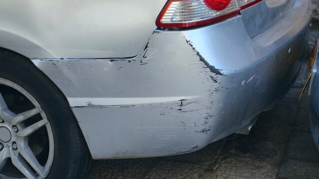 Scratched car paint. Damaged car in a car repair shop.