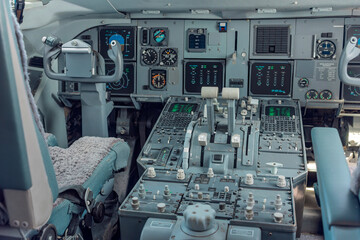 Angled view of a passenger aircraft flight deck showing the captain seat, instrument panels and the speed limitation placard in soft daylight. © Victor