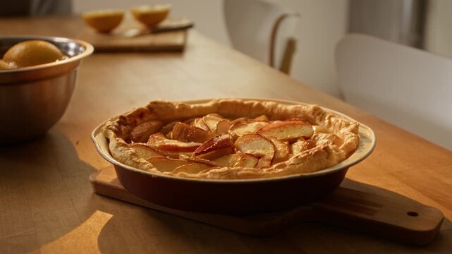 Freshly baked apple pie cooling in ceramic baking dish on wooden table. Visual asset perfect for culinary blogs, holiday cooking commercials, bakery marketing, and traditional recipe videos