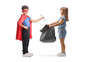 Fototapeta premium Superhero child collecting plastic bottles for recycling