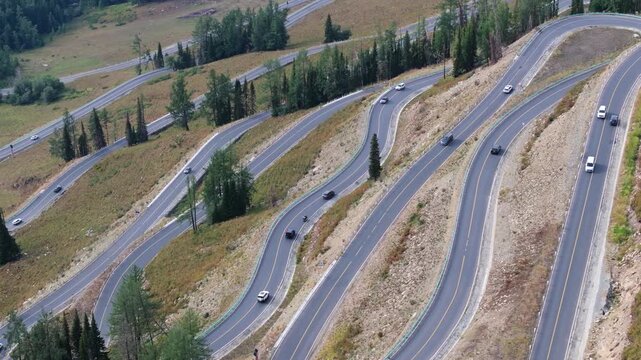 Aerial  view of cars driving on a sinuous road in Xinjiang,China