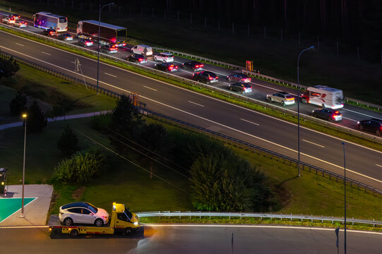 Aerial view of the Gajewo East Motorway Service Area on the A1 Motorway at night, with a tow truck, highway traffic, and street lighting in Nowe, Kuyavian-Pomeranian V, Poland.