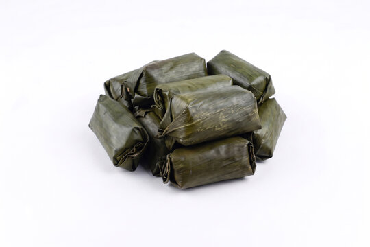 Pile of Lemper, Traditional Indonesian Savory Glutinous Rice Snack Wrapped in Banana Leaves, Isolated on White Background