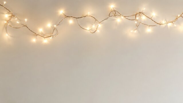 Warm glowing Christmas string lights forming a festive border with copy space