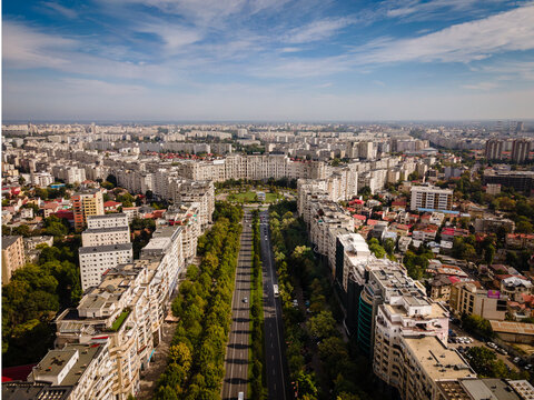 Aerial view of a wide boulevard lined with apartment buildings and trees in Bucharest, Bucharest, Romania.