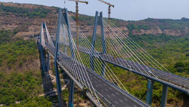 Aerial view of Missing Link Suspension Bridge with its tall pylons and cable-stayed design spanning a lush valley under a clear sky in Lonavala, Maharashtra, India.