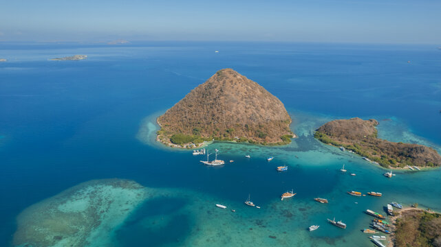 Aerial View of Tropical Island with Turquoise Lagoon and Boats in Komodo National Park, Indonesia