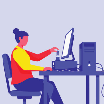 Person connecting USB drive to computer at desk