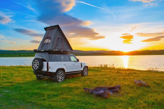 Off road car with roof tent in the wild campground.