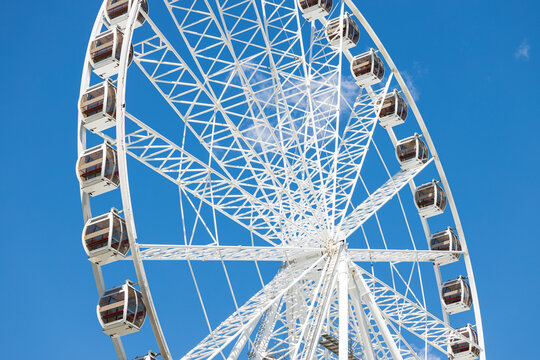 Ferris Wheel white construction structure on blue sky background
