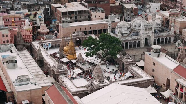 Aerial view of kashi vishwanath temple and gyanvapi mosque in varanasi, india, with crowd of pilgrims visiting