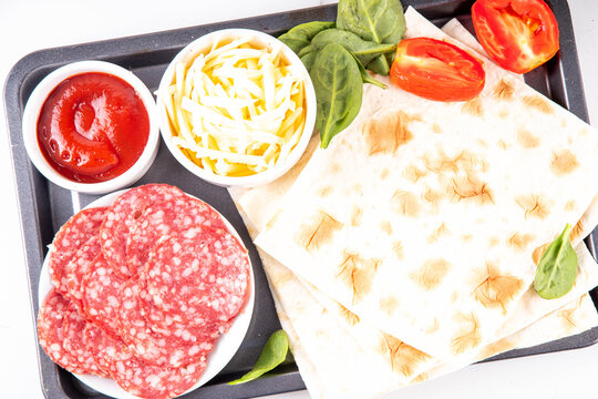 Flatbread Pepperoni Pizza. Viral pizza on tortilla pita bread, with tomato marinara sauce, grated cheese and pepperoni