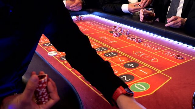 Players placing chips on numbers at a roulette table during a casino themed event