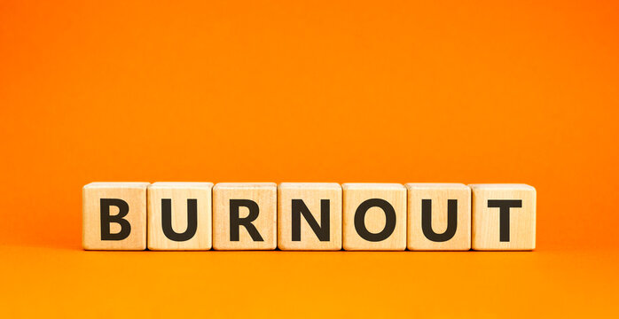 Burnout word symbol. Concept word Burnout on beautiful wooden blocks. Beautiful orange table orange background. Business medical burnout word concept. Copy space.