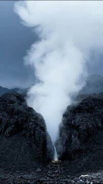 Volcanic eruption with thick ash cloud and lava flow from a rocky volcanic crater at dusk volcano volcanic activity volcanic landscape