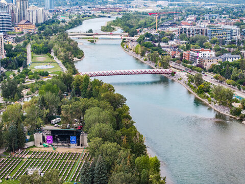 aerial landscape view along Bow River with Peace Bridge next to Downtown Calgary ( Alberta, Canada) with Prince's Island Park Stage on Prince's Island