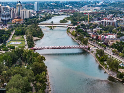 aerial landscape view along Bow River with Peace Bridge next to Downtown Calgary ( Alberta, Canada) with Sunnyside district on right river bank and Eau Claire on left river bank 