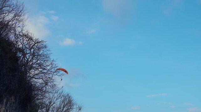 Paraglider Soaring in Clear Blue Sky