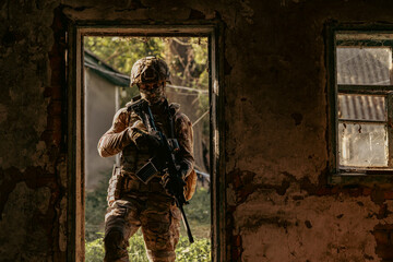Obraz premium A soldier inspects a destroyed house.
