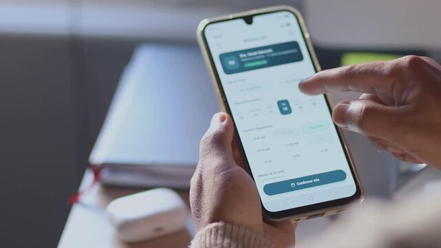 Person booking doctor appointment online using smartphone application and calendar for scheduling medical visit with a specialist