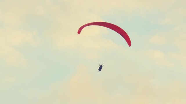 Paraglider in a Cloudy Sky