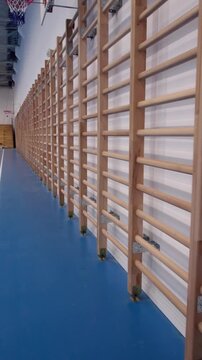 Empty school gymnasium with blue epoxy resin flooring