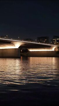Long exposure nighttime bridge scene with light trails and city lights reflecting on water long exposure photography city lights reflection