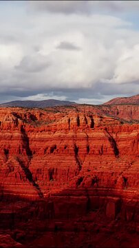 Aerial drone footage of the iconic horseshoe bend in the grand canyon during golden hour with red rock cliffs and colorado river below