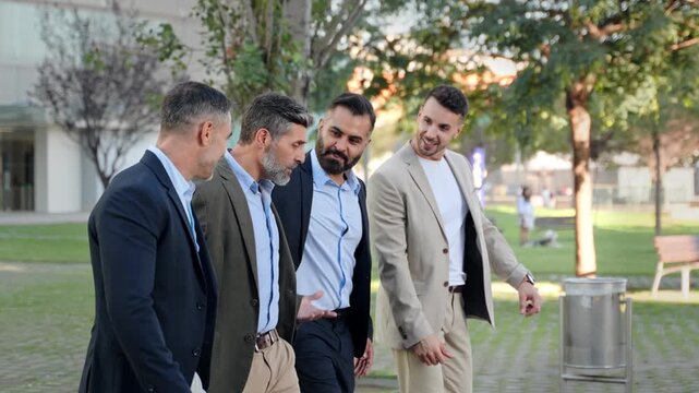 Business partners having a conversation while walking in the city after work - Hispanic, Arab and Indian Professional Male Company