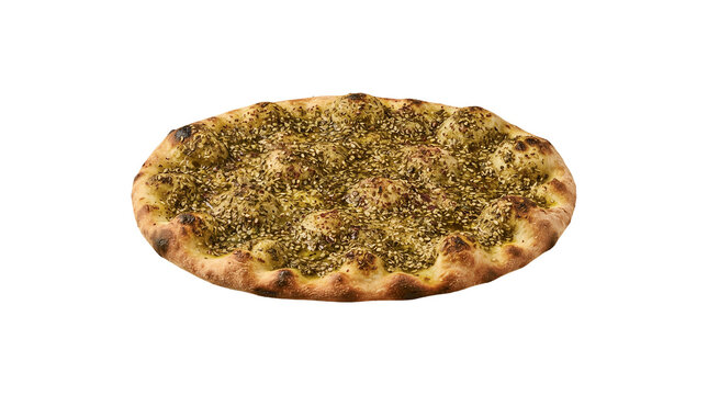 Freshly baked artisan flatbread pizza topped with green herbs and sesame seeds rests on a neutral grey background.