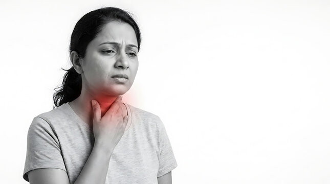 Contemplative woman experiencing throat discomfort feeling unsure about health concerns in a monochrome setting