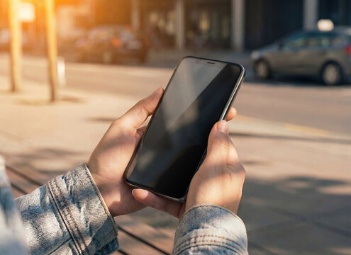 Woman Holding Smartphone on City Street