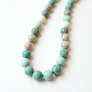 Handknotted mala necklace with matte amazonite beads in soft pastel shades on white background