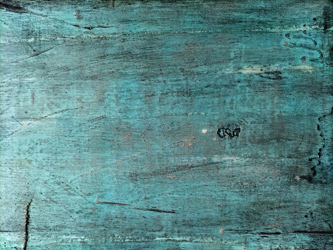Old rustic wood grain background featuring peeling light blue paint and a rugged, time-worn texture.