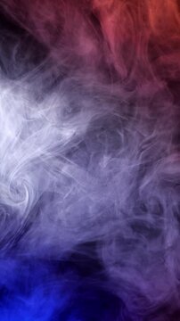 Colored smoke swirls over a dark background. Layered white and purple wisps drift through deep blue tones.