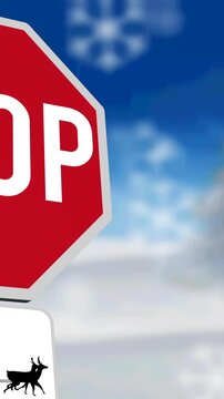 Animation of snowflakes over stop sign with santa claus in sleigh with reindeer in winter scenery