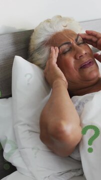 Animation of question mark symbol over senior woman suffering from headache