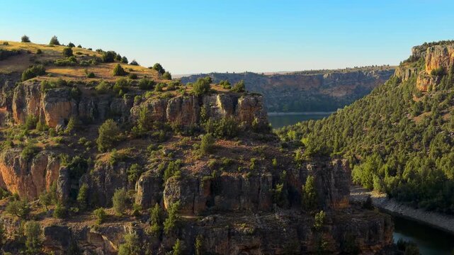 Hoces del Duraton canyon panning view, Segovia Spain. River cliff walls, pine forest slope and limestone rock in natural park. High quality 4kr footage