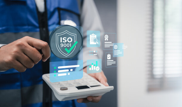 Quality audit analysis concept industrial worker using magnifying glass and calculator for ISO 9001 standard certification precise inspection compliance measurement and QA evaluation
