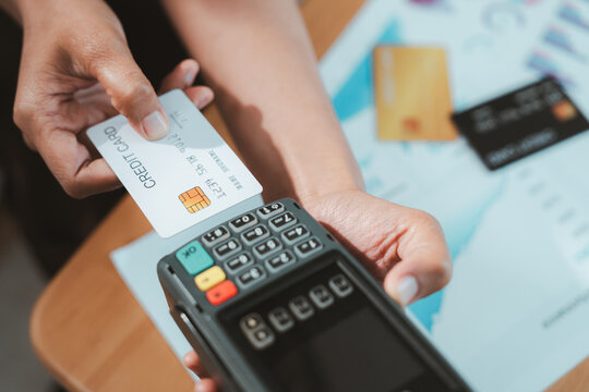 Contactless payment terminal and bank card support financial advisor wealth planning for secure retail transaction with hands and paperwork