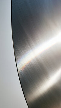 Brushed Metal Surface with Curved Edge and Light Reflection