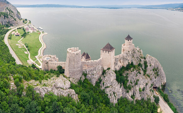 Wide-angle aerial panoramic frame places stone towers of Golubac fortress with the Danube gorge receding behind